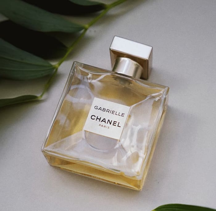 A bottle of Chanel Gabrielle Eau de Parfum sitting on a table.